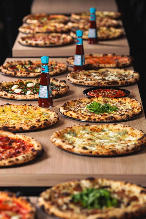 A lavish spread of various Ignite Pizzeria stone-fired pizzas ready for catering in Vancouver